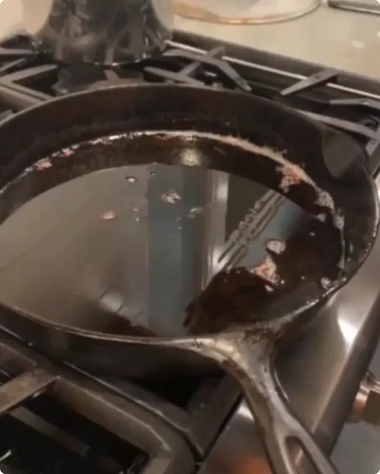 Used cooking oil in a cast iron pan on the stove